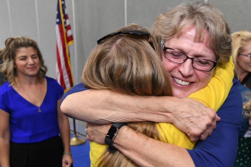 Melody Mansfield Milken Schools hugs from colleagues JEA 2017 Melody Mansfield Milken Schools hugs from colleagues JEA 2017